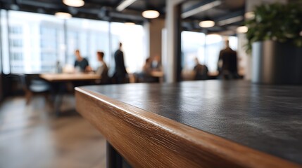Fototapeta premium Close up view of a modern office table foreground with blurred people and workspace in the background