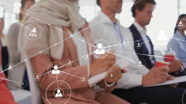 Camera panning left causing network overlay growing over seated group noting to show networking