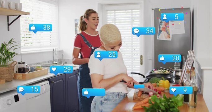 Chopping vegetables, women in white tee and red overalls prepping meal in home kitchen with icons