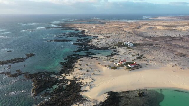 Aerial view of Fuerteventura coast between La Barra islets and Los Islotes with El Toston lighthouse in background