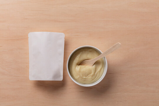 Still Life Pack Shot of Empty Baby Food Packaging with Product Sample