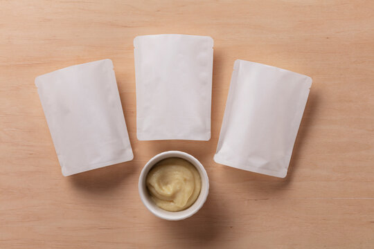 Still Life Pack Shot of Empty Baby Food Packaging with Product Sample