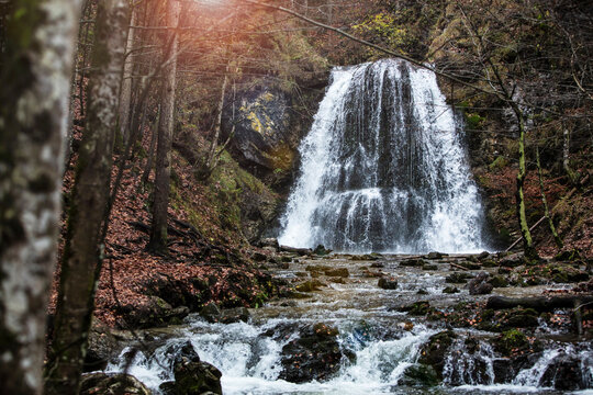 Mountain Waterfall Surrounded by Colorful Autumn Trees