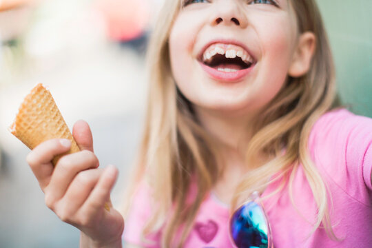 Happy Young Girl Enjoying an Ice Cream Cone