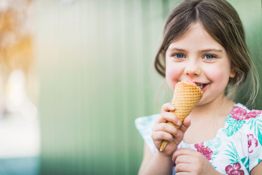Happy Young Girl Enjoying an Ice Cream Cone