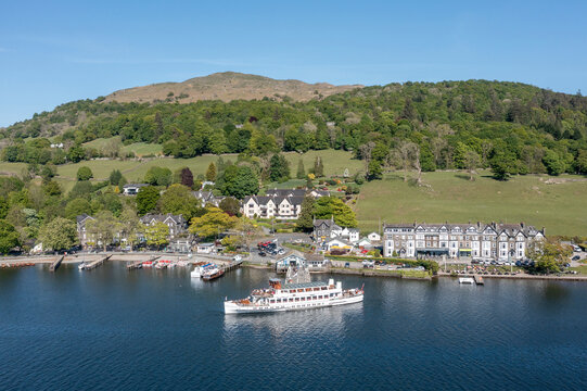pleasure cruise boat arriving at the boat landings at waterhead ambleside lake district cumbria uk aerial view logos removed
