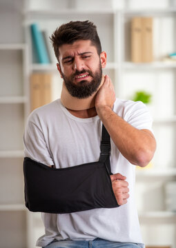 Man with neck brace and arm sling.