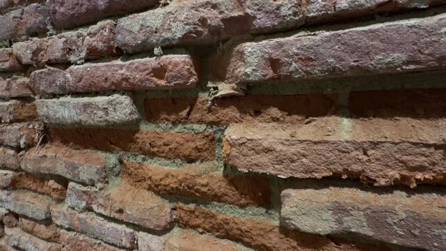 Close-up rough old red crumbling brick wall masonry texture pattern