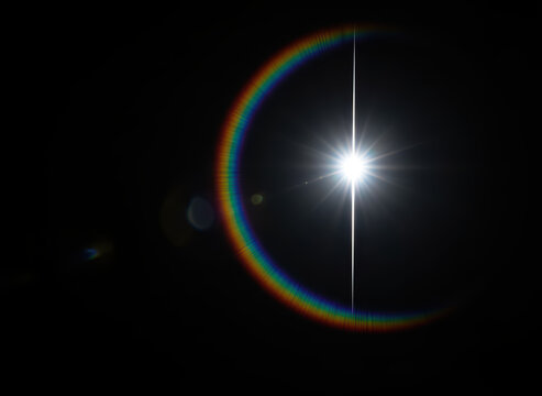 Bright Optical Lens Flare with Rainbow Halo on Black Background