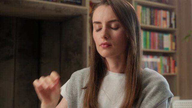 Tired Caucasian woman removing glasses eyes strain pain headache in library stressed student female girl overworked take off eyeglasses fatigue health problem migraine school studying education indoor