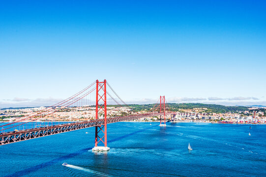 The 25 de Abril Bridge is a iconic red suspension bridge in Lisbon, Portugal, inaugurated on August 6, 1966, to connect the city with Almada over the Tagus River.
