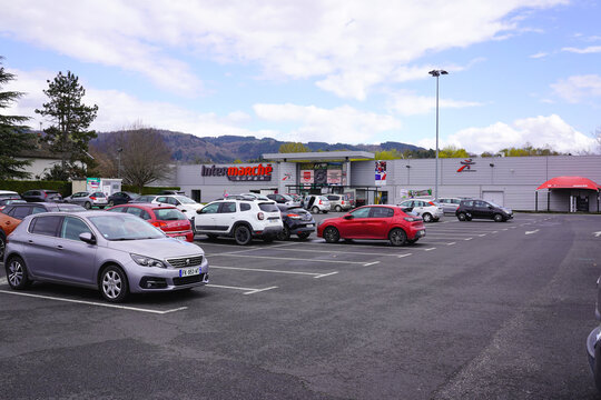 THIERS, FRANCE - MARCH 31, 2026: Intermarche Super store facade and parking lot with cars.