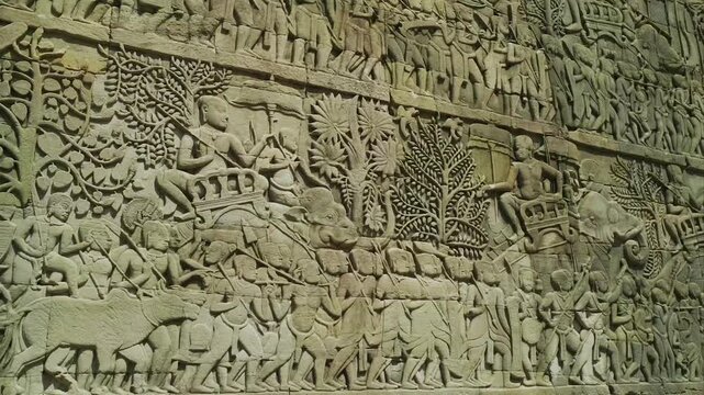 Stone carving depicting a war procession with soldiers and elephants on an ancient temple wall