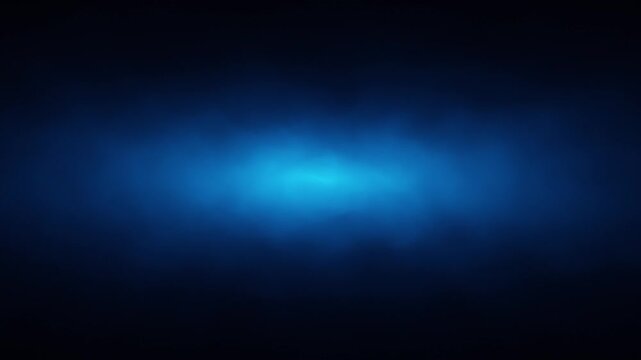 Dark blue volumetric light emerging through soft smoke. Glowing mist creates atmospheric depth and cinematic abstract background with subtle slow motion.