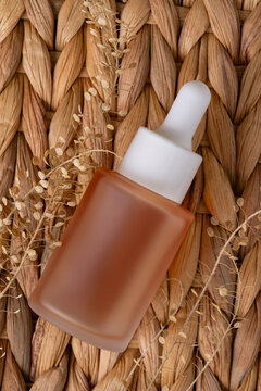Natural skincare oil on woven wicker basket
