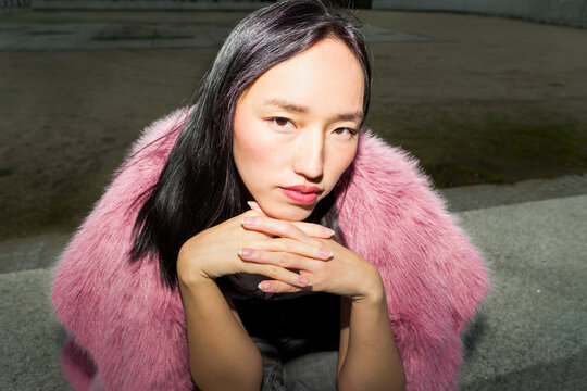 Portrait of young woman embracing urban lifestyle