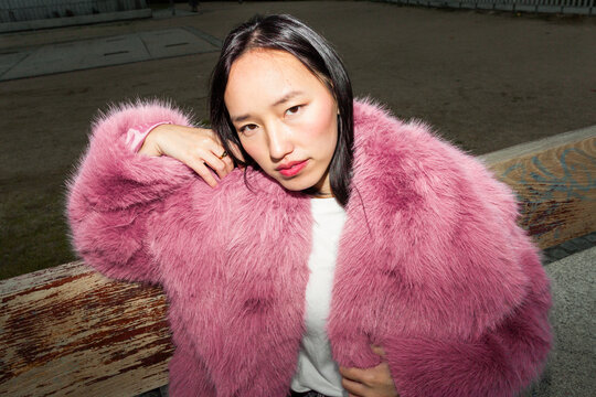 Urban lifestyle portrait of a woman in pink fur