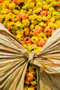 Marigold flowers wrapped in colorful fabric in India