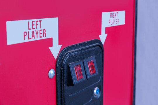 Retro arcade game coin slots. Left and right player. Red cabinet.