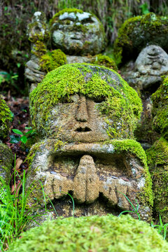 stone Close-up view of praying stone statue covered in moss at Otagi nenbutsu-ji temple in Arashiyama, Kyoto, Japan 