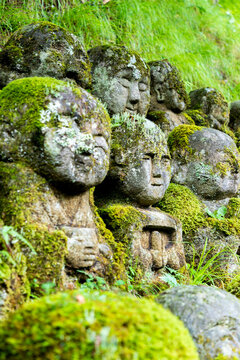 Moss covered Buddhist stone statues at the Otagi Nenbutsu-ji temple in Kyoto, Japan