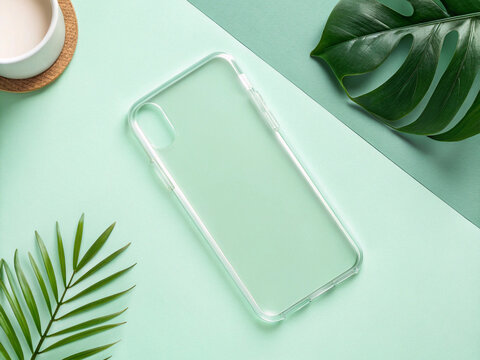 Clear Smartphone Case with Tropical Palm and Monstera Leaves Flat Lay on Mint Green