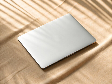 Silver Laptop Flat Lay on Warm Beige Gold Satin Fabric Background Elegant Workspace