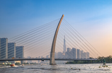 Naklejka premium Sunrise from river over bridge in Saigon (Ho Chi Minh City)