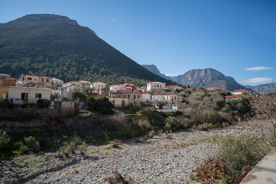 Scenic view of Leonidio, Arcadia, Greece with hills, rocks and small houses with red roofs on the coast, tourist and climbing resort