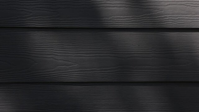 4k video b roll of dappled light tree foliage moving in breeze casting shadows on dark gray home exterior horizontal plank lines