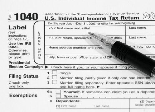 IRS Tax Form 1040 with Pen Closeup U.S. Income Tax Filing Concept