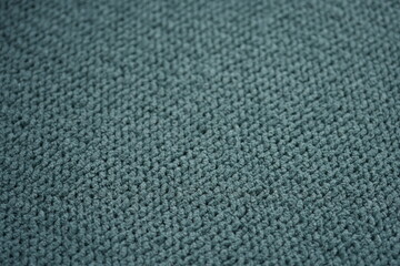 Fototapeta premium macro texture of soft green plush fabric. Close-up of cozy textile surface with delicate fibers and calm natural tones. Smooth and slightly fuzzy texture creates a relaxing background perfect for eco 