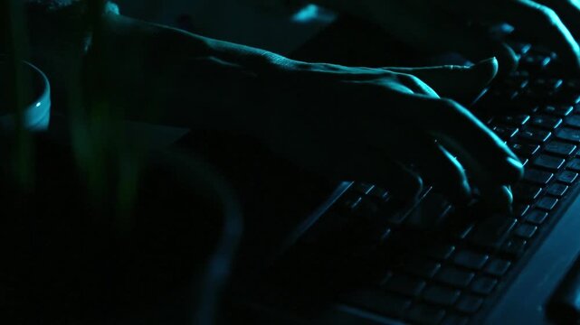 Business woman typing the fingers on keyboard with writing the pen in hand with sound.  Low key shadow with blue color art lighting. Closeup abstract  series of videos from different angles