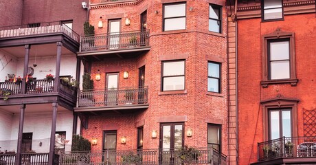 Elegant red brick residential facades with balconies in New York City