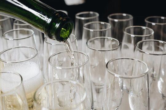 Pouring Champagne into Clear Glasses