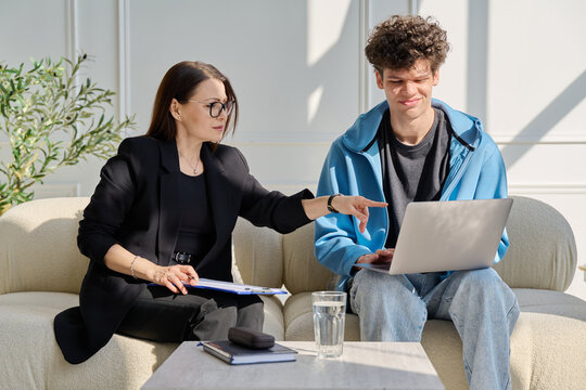 Psychological session therapy, young guy and therapist looking at computer together