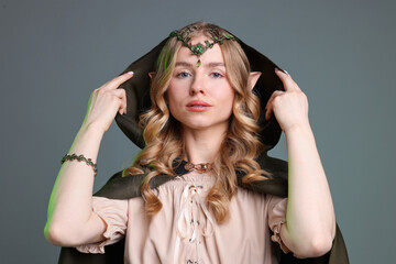 Obraz premium Portrait of beautiful elf girl on grey background