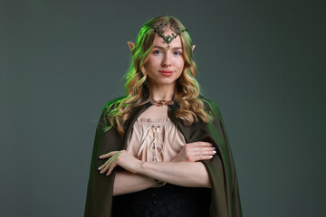 Obraz premium Beautiful girl dressed as elf on grey background