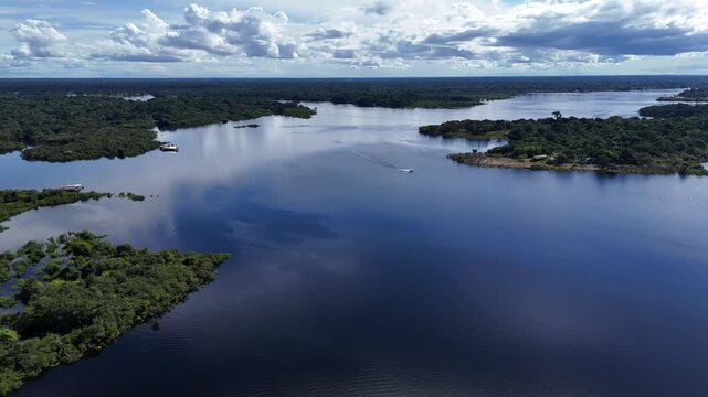 Aerial drone view of seaplane taking off on Amazon river surrounded by rainforest