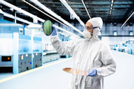 Inspecting semiconductor production, photolithography and Indian man optimizing infrastructure. Trialing advanced materials, silicon wafers, and scientist doing research and development