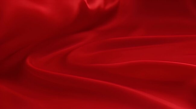 Abstract red fabric background with soft folds and flowing, elegant texture