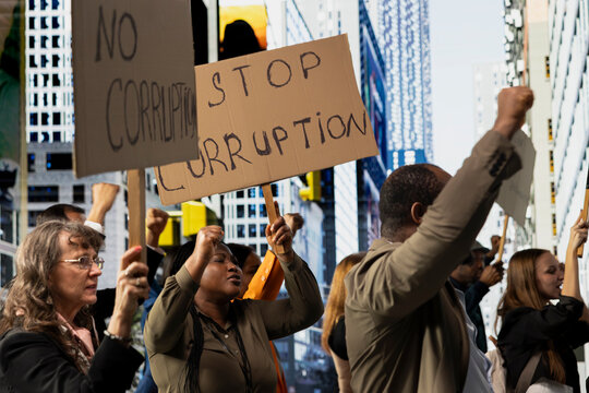 Activists taking part in a political protest near parliament building, raising awareness against corrupt politics, misconduct and scandalous government behavior. Democratic reform.