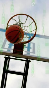 Shooting player in tank top reaching hoop at park, orange basketball sinking net, binary overlay