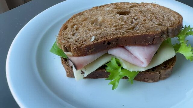 Serving a Delicious Ham and Swiss Cheese Sandwich on Wheat Bread