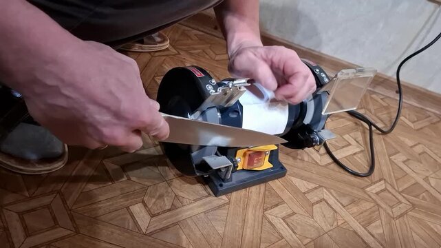 Sharpening a large knife using a sharpening machine in a home setting