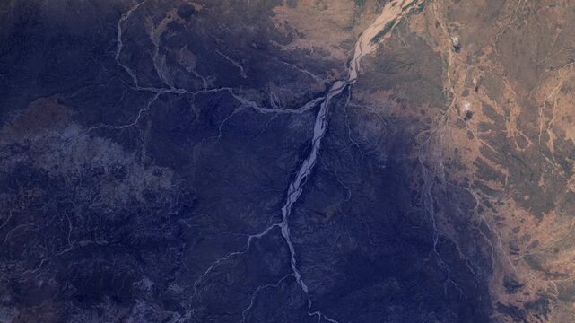 Sunrise timelapse over Darfur Sudan wadi river landscape satellite view from space based on Nasa imagery