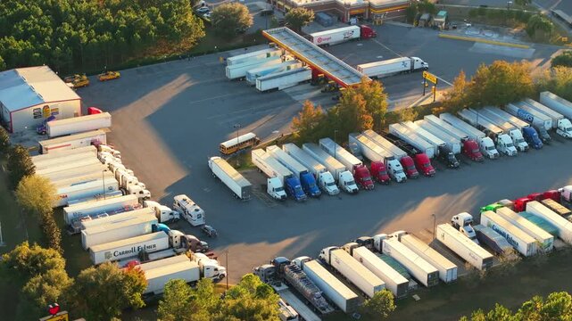 Roadside parking area for trucks on interstate highway, serving as convenient stop for truck drivers on long drives.