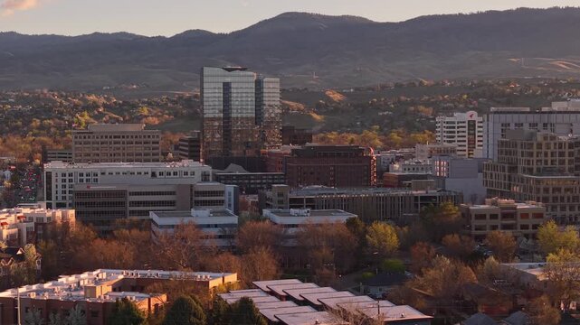 Drone flyover of a beautiful sunrise over downtown Boise, Idaho skyline. The Arthur building, and the 11th & Idaho building are visible.