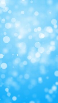 Vertical portrait orientation seamless loop of abstract blue bokeh light particles. Soft glowing spheres waving for mobile screens, social media Reels, and TikTok stories. 3D render.