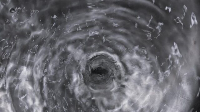 Close up of boiling water in a stainless steel pot in slow motion